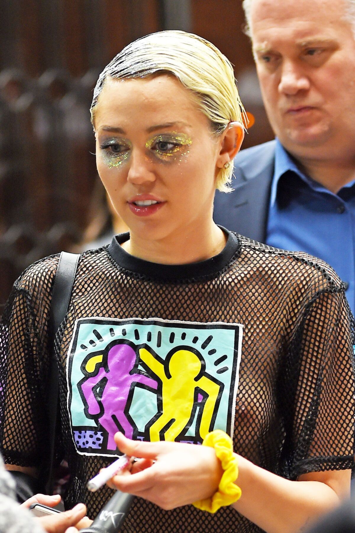 Miley Cyrus see through shirt in public