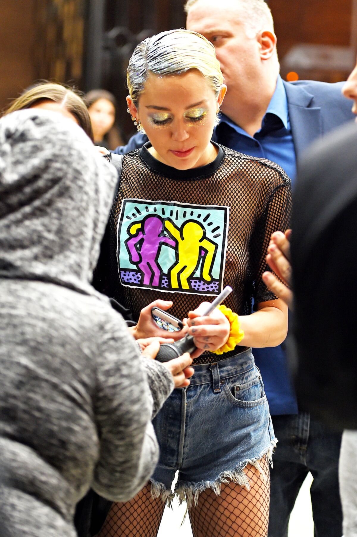 Miley Cyrus see through shirt in public