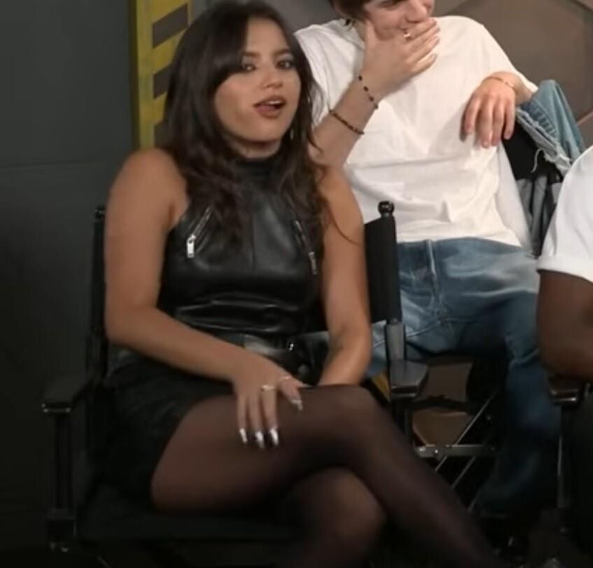 Isabela Merced touching her pantyhose legs in interview