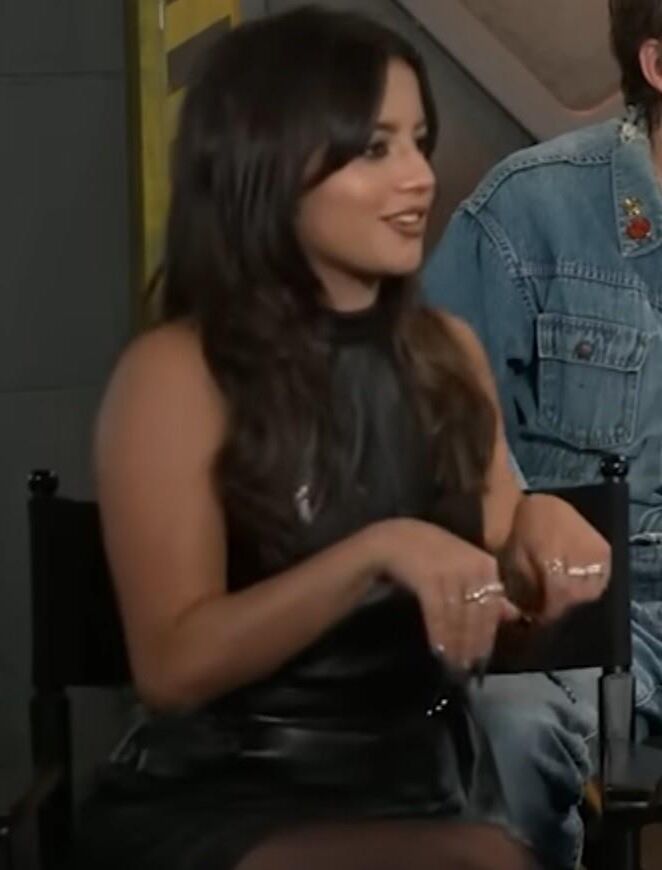 Isabela Merced touching her pantyhose legs in interview