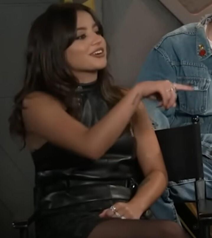 Isabela Merced touching her pantyhose legs in interview