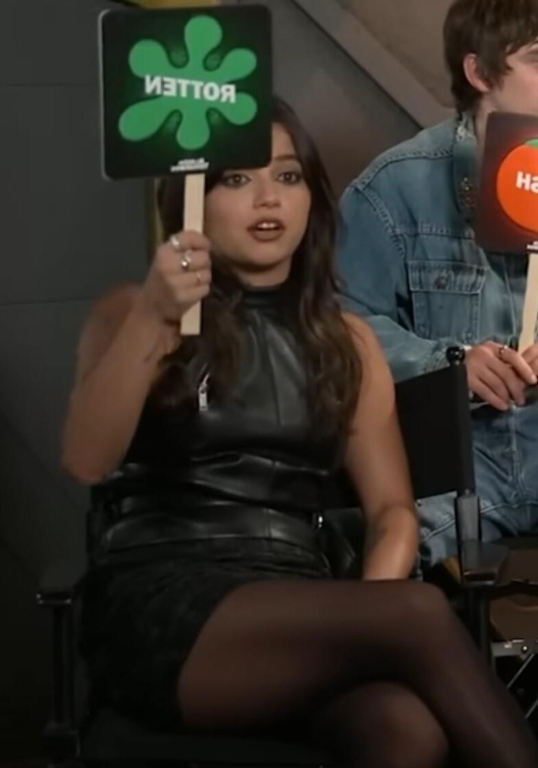 Isabela Merced touching her pantyhose legs in interview