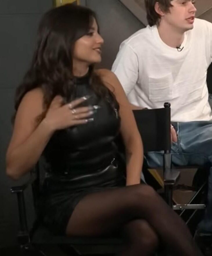 Isabela Merced touching her pantyhose legs in interview