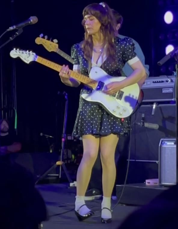 Jenny Lewis in fishnets, frilly white socks, and mary jane heels