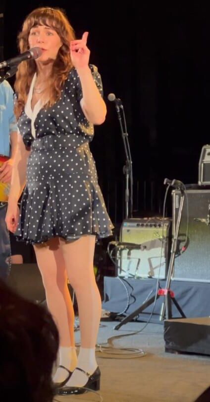 Jenny Lewis in fishnets, frilly white socks, and mary jane heels