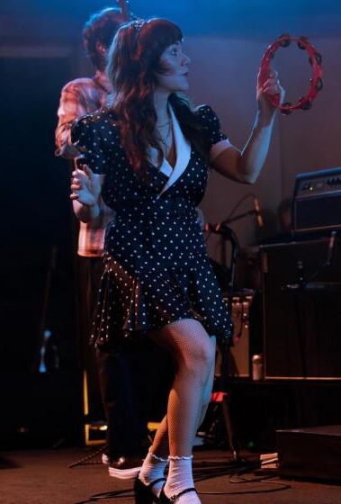 Jenny Lewis in fishnets, frilly white socks, and mary jane heels