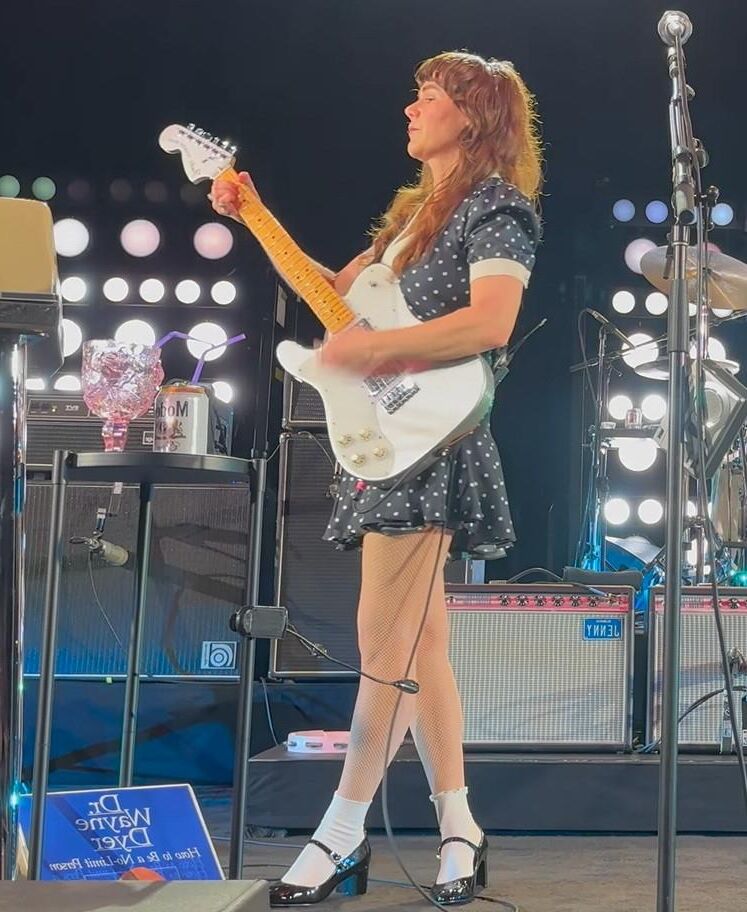 Jenny Lewis in fishnets, frilly white socks, and mary jane heels