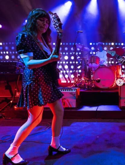 Jenny Lewis in fishnets, frilly white socks, and mary jane heels
