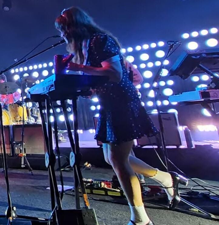 Jenny Lewis in fishnets, frilly white socks, and mary jane heels