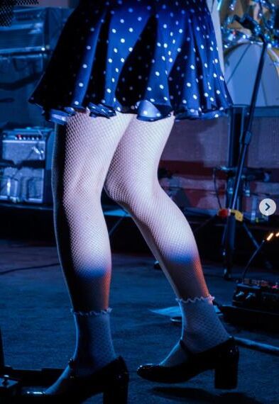 Jenny Lewis in fishnets, frilly white socks, and mary jane heels