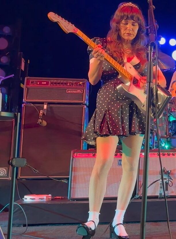 Jenny Lewis in fishnets, frilly white socks, and mary jane heels