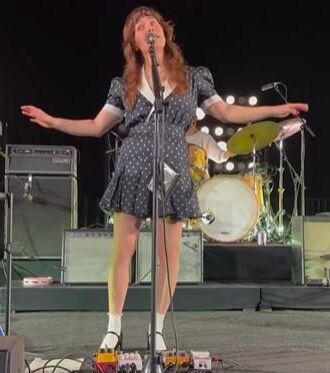 Jenny Lewis in fishnets, frilly white socks, and mary jane heels