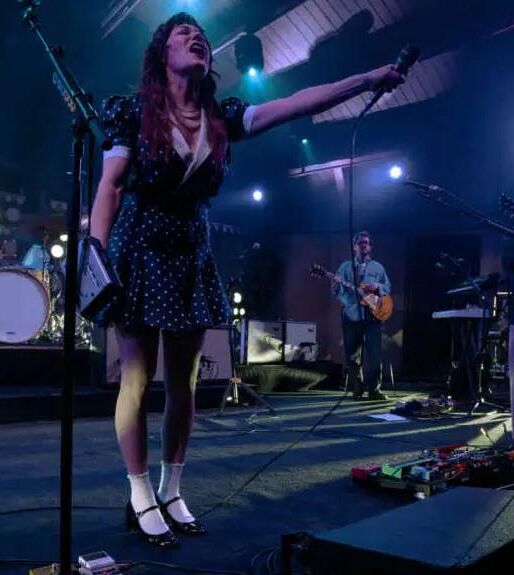 Jenny Lewis in fishnets, frilly white socks, and mary jane heels
