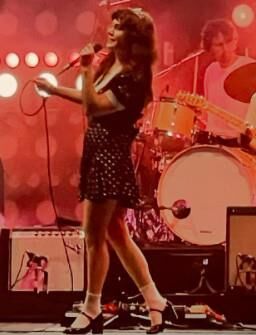 Jenny Lewis in fishnets, frilly white socks, and mary jane heels