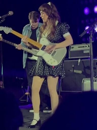 Jenny Lewis in fishnets, frilly white socks, and mary jane heels