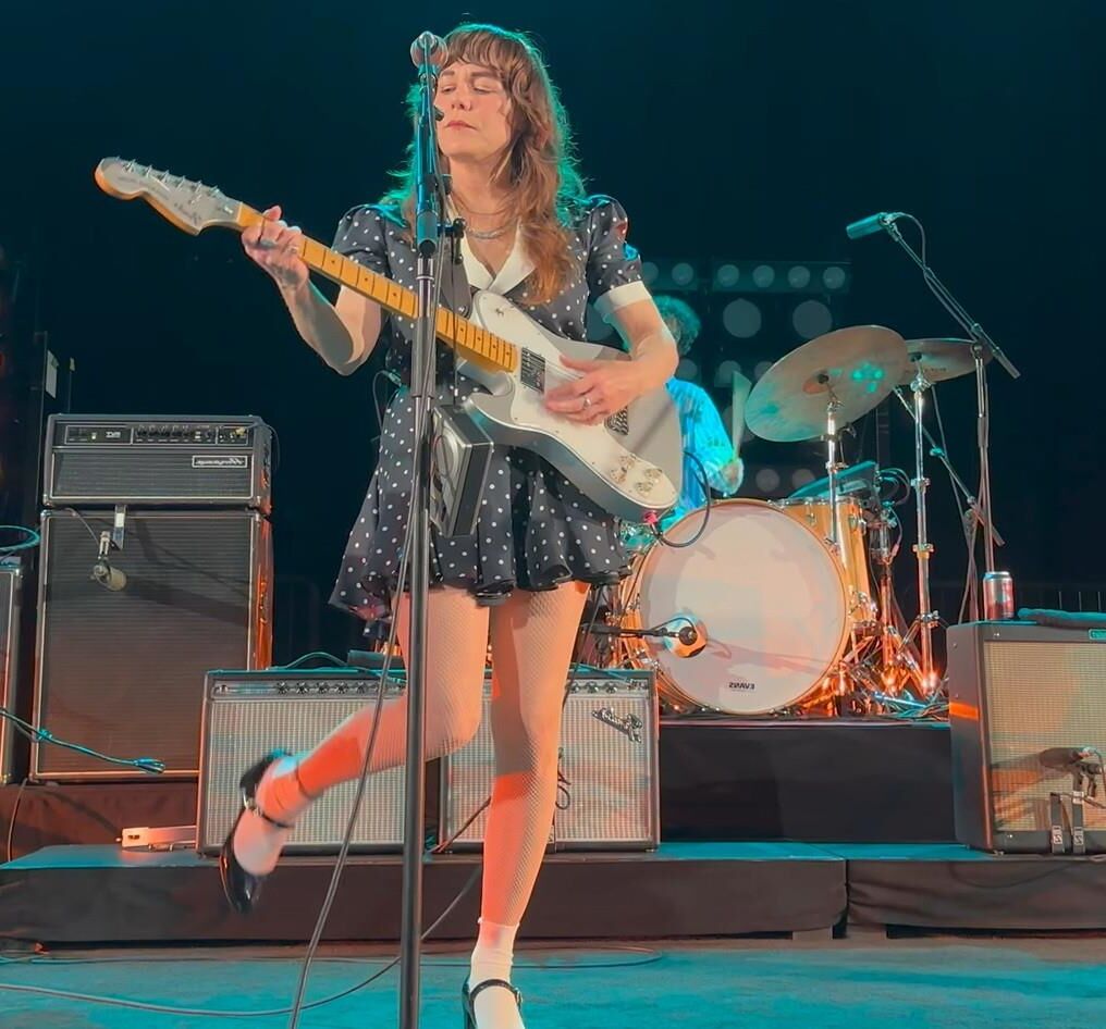 Jenny Lewis in fishnets, frilly white socks, and mary jane heels