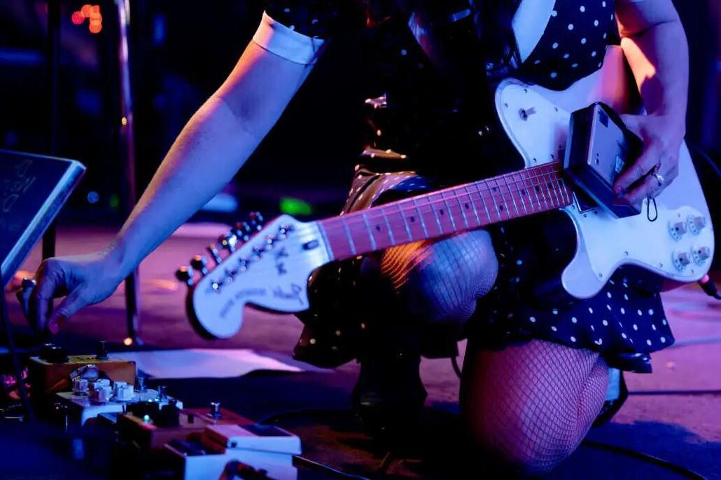 Jenny Lewis in fishnets, frilly white socks, and mary jane heels