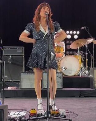 Jenny Lewis in fishnets, frilly white socks, and mary jane heels