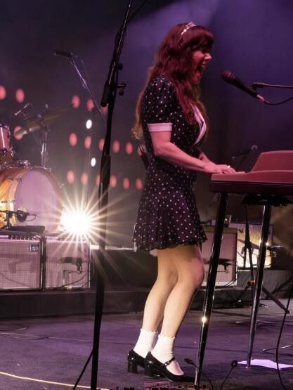 Jenny Lewis in fishnets, frilly white socks, and mary jane heels