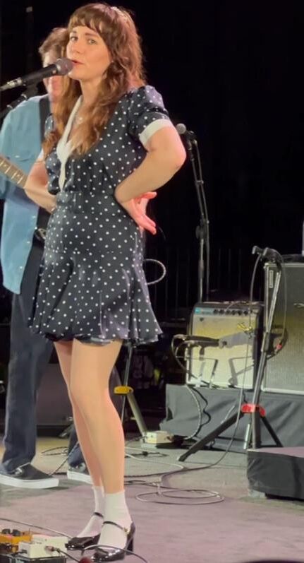 Jenny Lewis in fishnets, frilly white socks, and mary jane heels