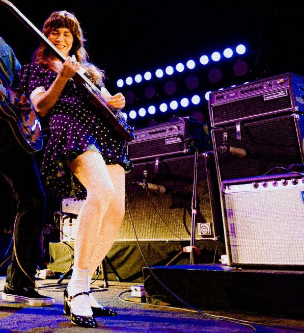 Jenny Lewis in fishnets, frilly white socks, and mary jane heels