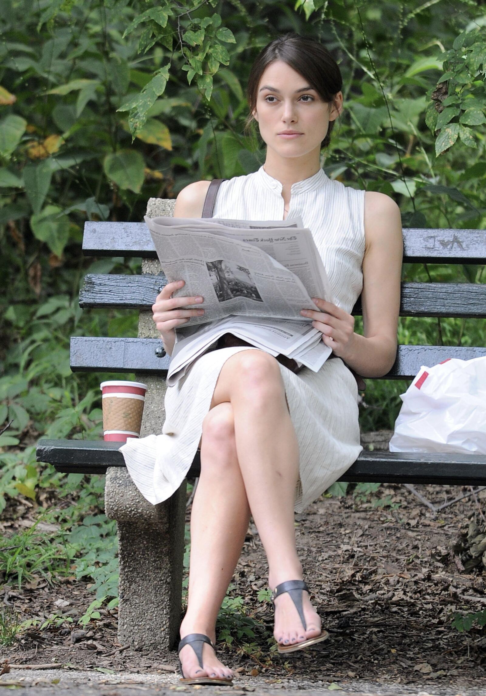 Kiera and her newspaper in the park 